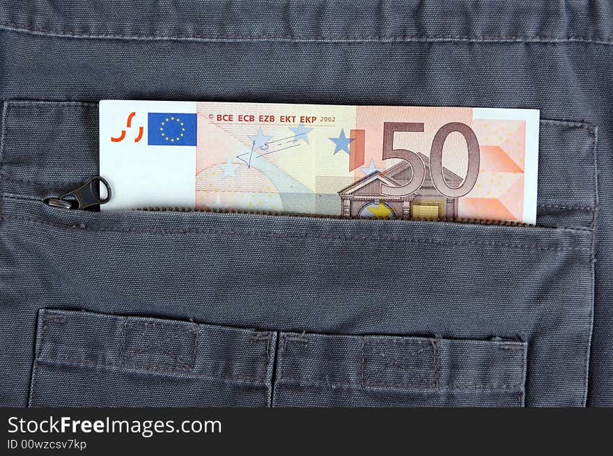 Euro in the pocket of a casual garment.  Photographed in a studio.