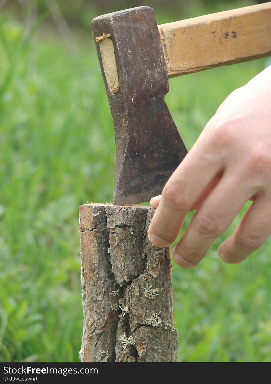 Wooden chuck and metal axe with fingers. Wooden chuck and metal axe with fingers