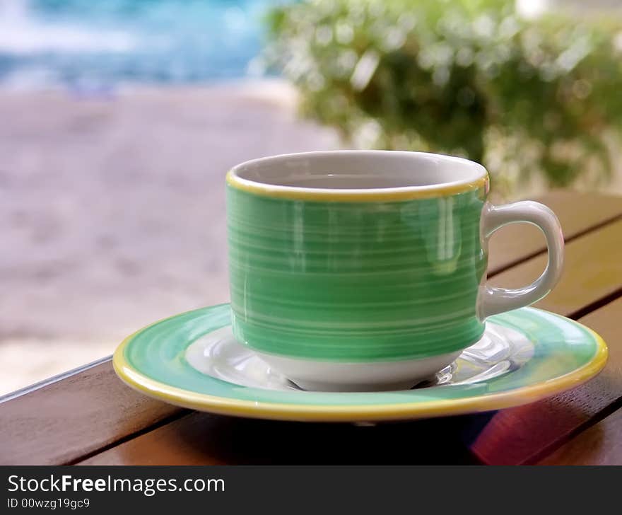 Green cup on wood table. March Break. Relaxation. Green cup on wood table. March Break. Relaxation.