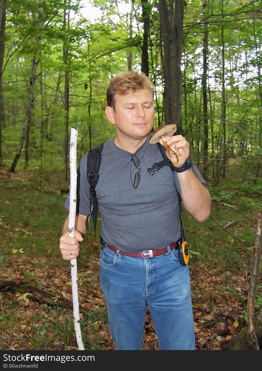 Mushroomer with mushroom in his hand. Fall Forest