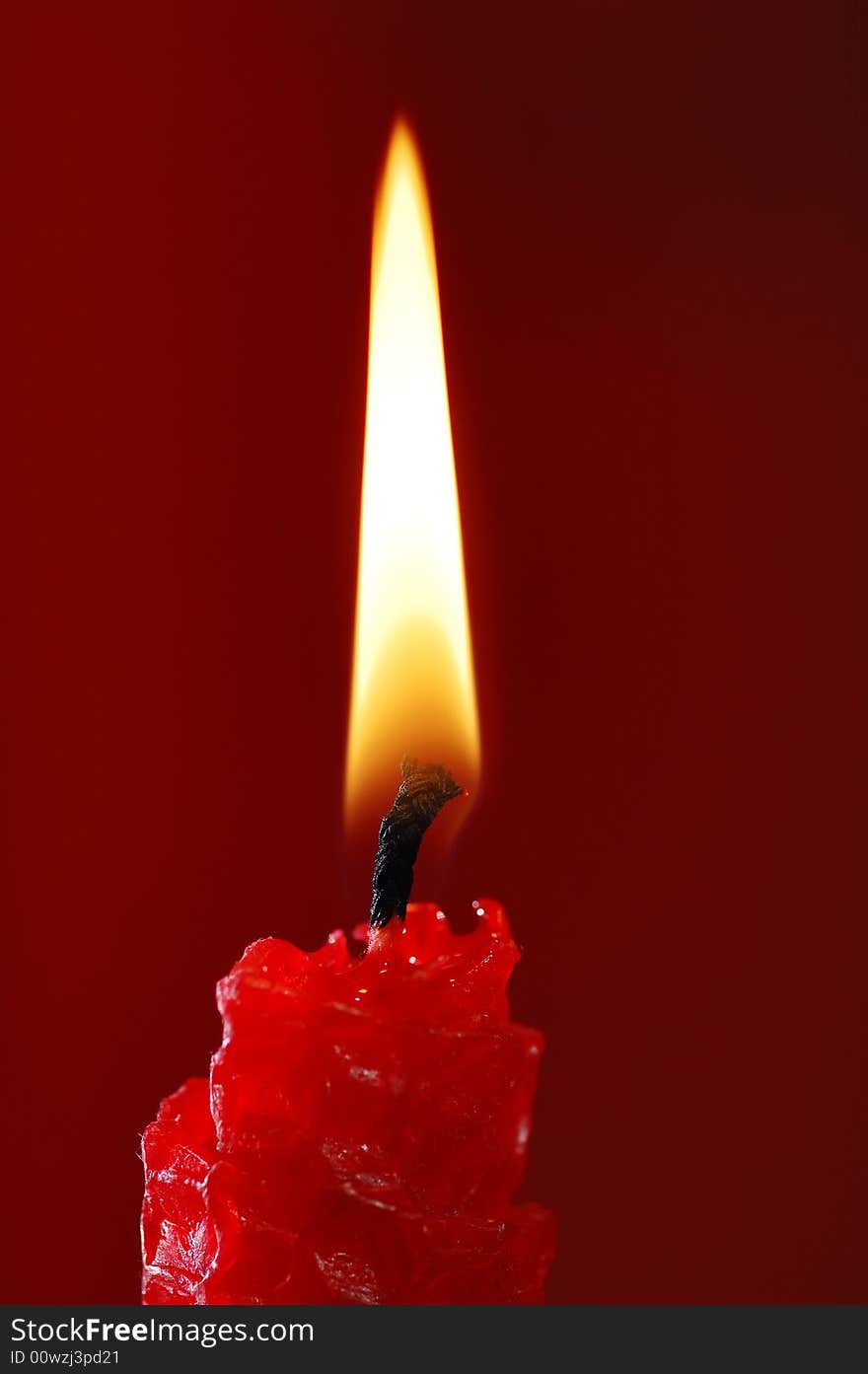 Red candle on the red background. Red candle on the red background.