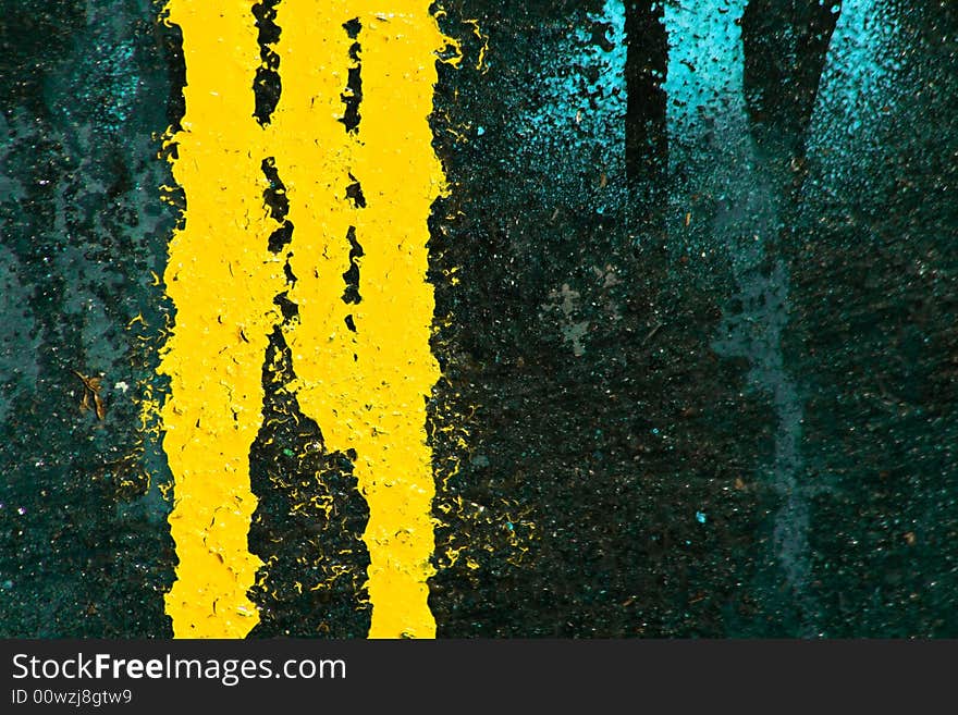 Yellow and blue paints leaking on dark background