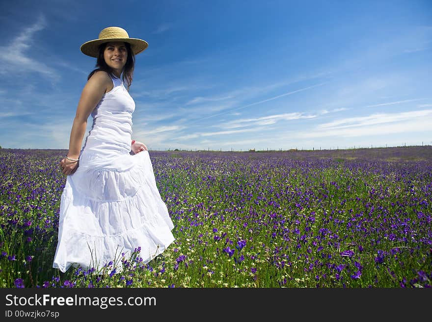 Beautiful young woman with white dress in colorful landscape. Beautiful young woman with white dress in colorful landscape