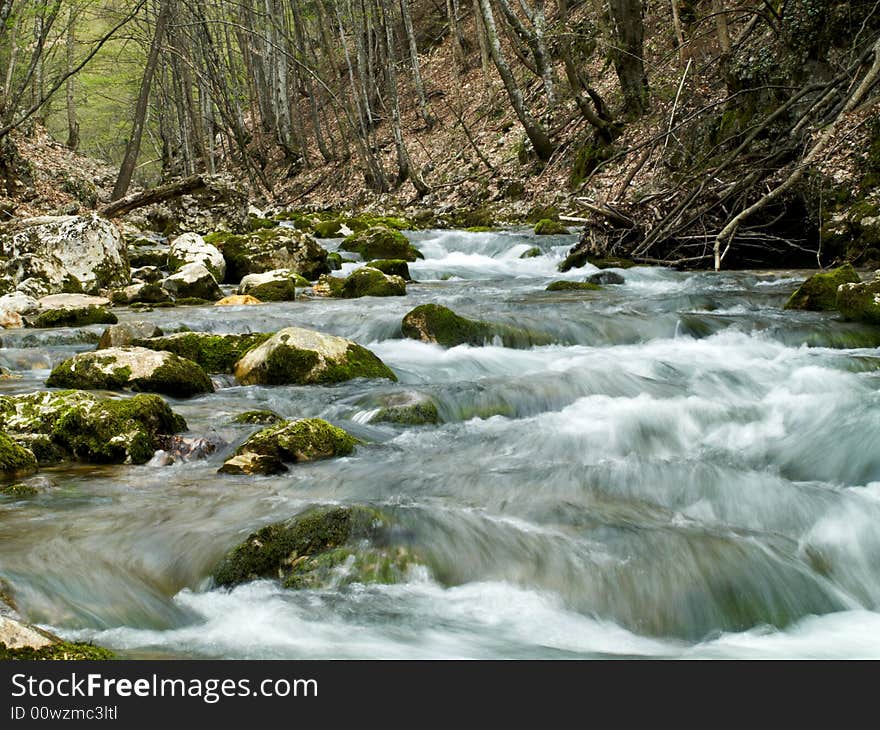 Forest stream running over mossy rocks, long exposure. Forest stream running over mossy rocks, long exposure