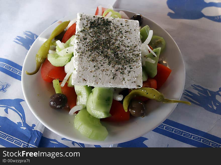 Greek salad in bowl on desk