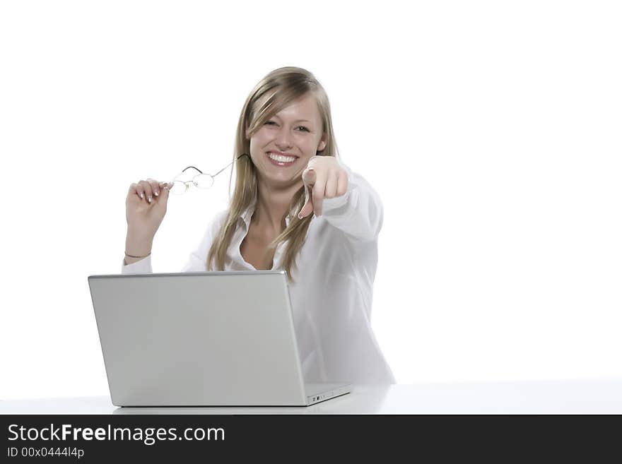 Young blond woman pointing finger at camera, holding laptop, studio shot isolated on white background. Young blond woman pointing finger at camera, holding laptop, studio shot isolated on white background