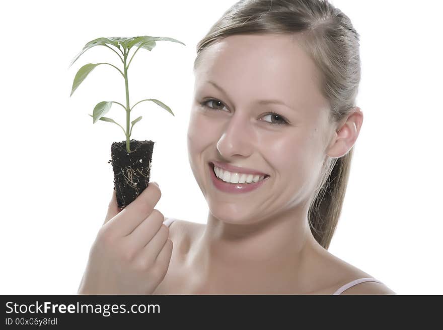 Young woman holding young sprout in the hands.