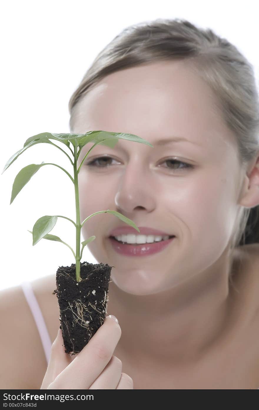 Young Woman Holding Young Sprout In The Hands.