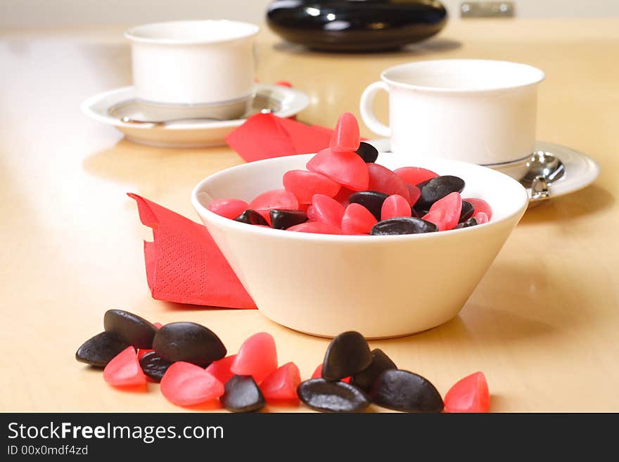 Candy with coffee cups in the background. Candy with coffee cups in the background