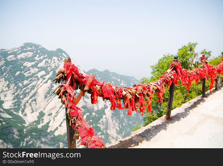 Pilgrims tie red ribbons to the trees outside of the taoist temple. Recently-married locals will climb to the summits to add a lock the chains to symbolize their everlasting love. A similar practice is done on the Great Wall. Pilgrims tie red ribbons to the trees outside of the taoist temple. Recently-married locals will climb to the summits to add a lock the chains to symbolize their everlasting love. A similar practice is done on the Great Wall.