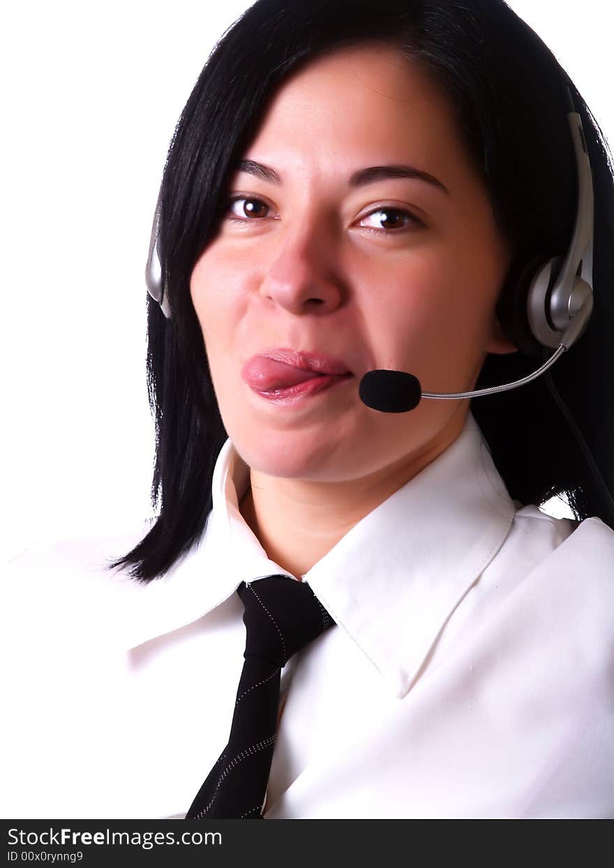 A portrait about a young pretty customer service representative lady with black hair who is smiling, sticking out her tongue, she has a headphone, and she is wearing a white shirt and a black tie. A portrait about a young pretty customer service representative lady with black hair who is smiling, sticking out her tongue, she has a headphone, and she is wearing a white shirt and a black tie