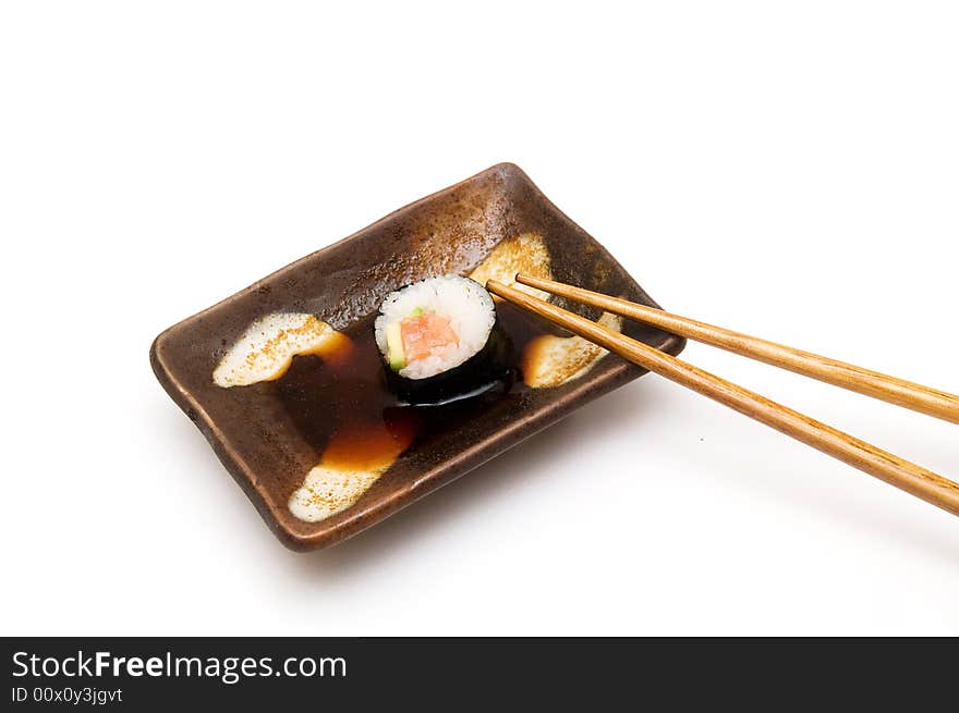 Salmon roll with avocado in soy isolated om white. Salmon roll with avocado in soy isolated om white