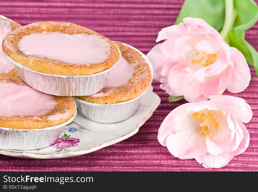 Cakes with raspberry frosting decorated with pink tulips. Cakes with raspberry frosting decorated with pink tulips