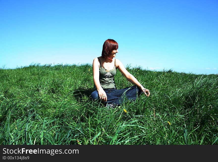 Young girl sittin on the grass. Young girl sittin on the grass