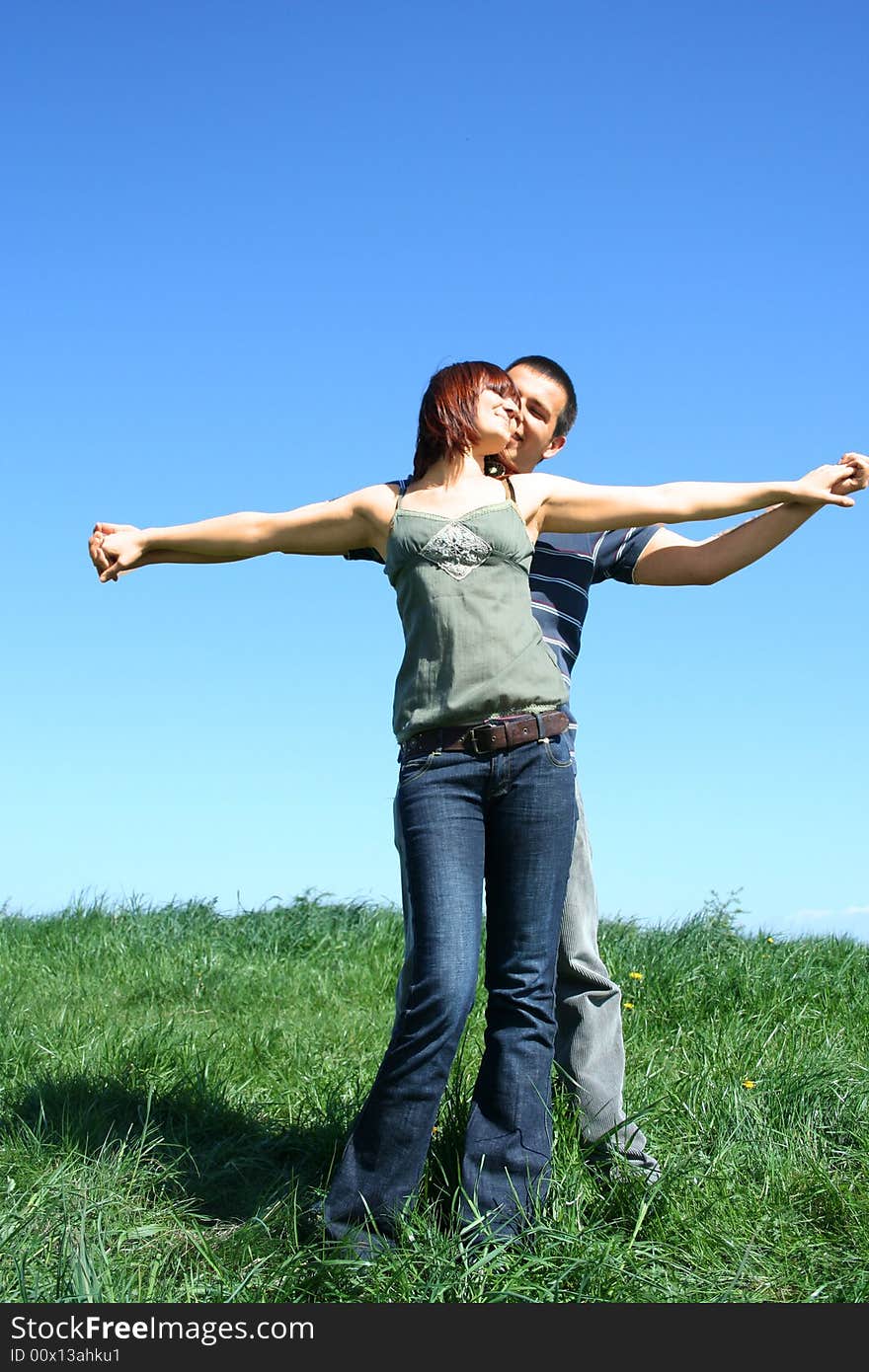 Young couple standing on the grass. Young couple standing on the grass