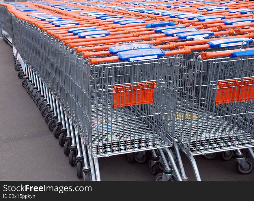 Metallic shopping carts row details inside each other. Metallic shopping carts row details inside each other