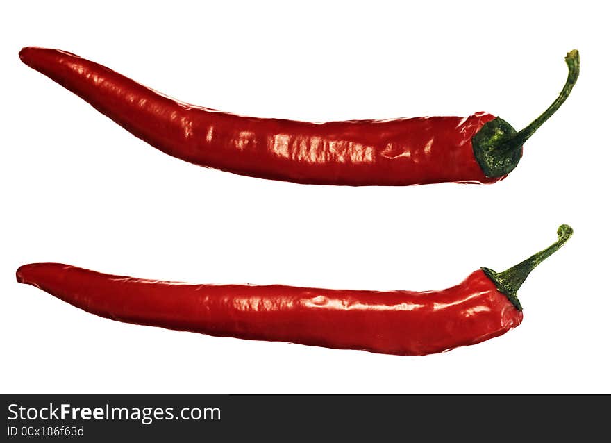 Two red hot peppers over white