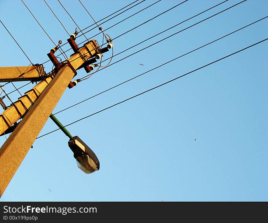 Power line pole on blue sky background. Power line pole on blue sky background