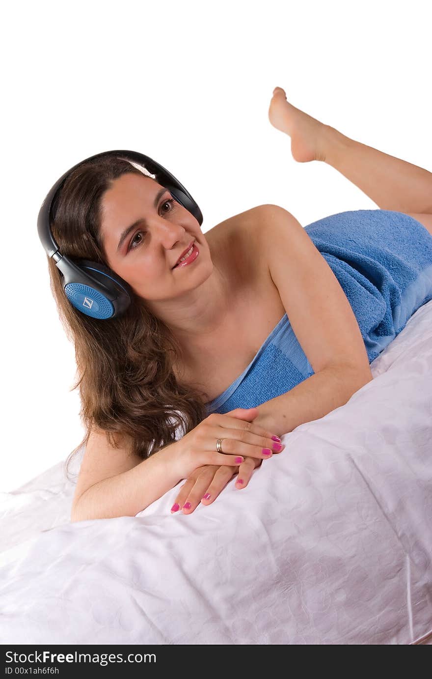 Beautiful girl in blue towel with headphones