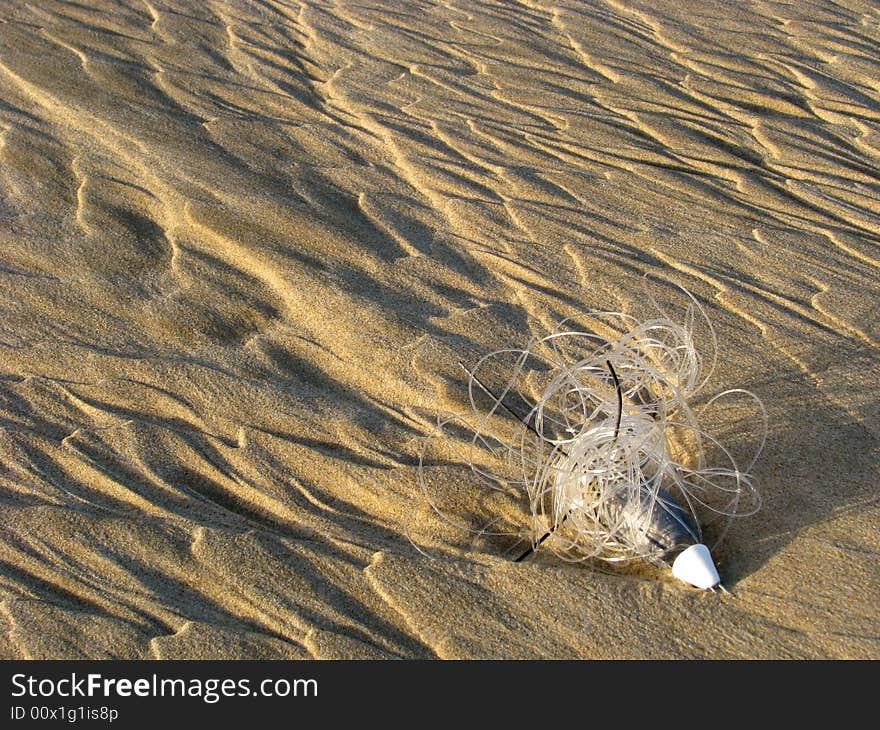 A line and sinker that washed up onto the beach sand