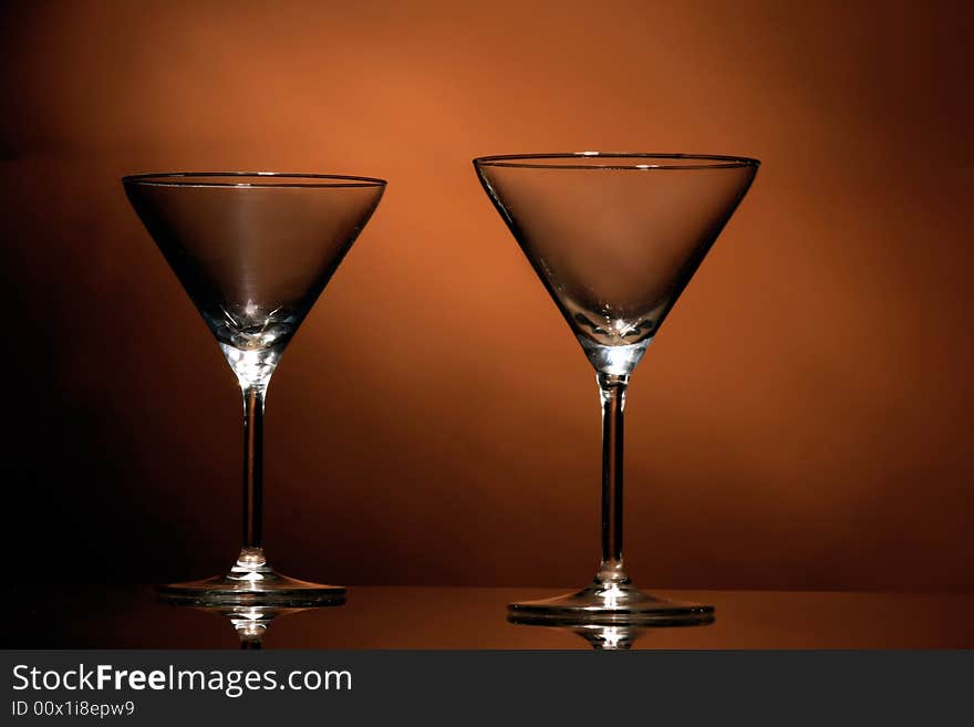 A two wine glasses on the orange background