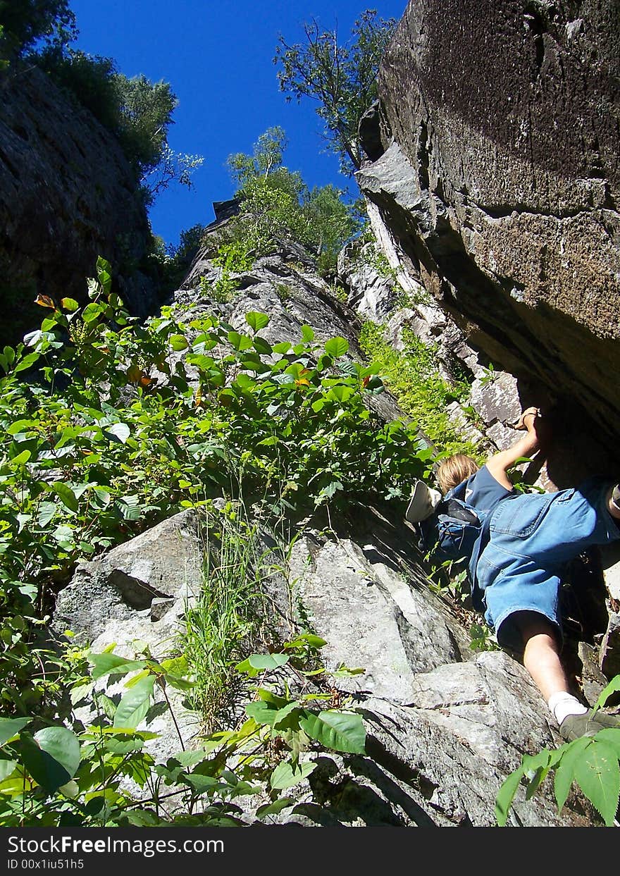 A man climbing Robertson Lake Cliffs in Ontario, Canada. A man climbing Robertson Lake Cliffs in Ontario, Canada.