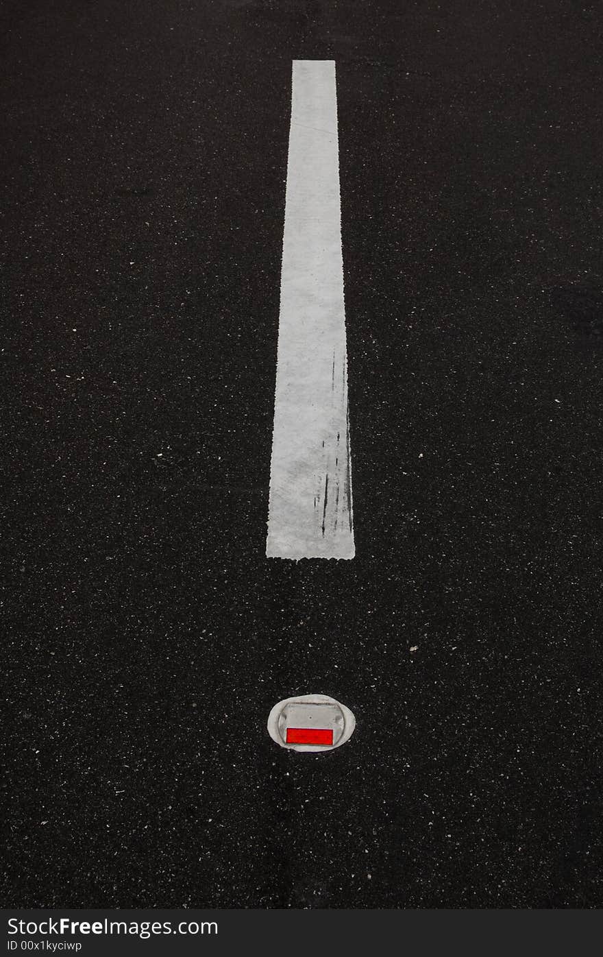 A road line with a red reflector, it looks like an exclamation point.  Great for highway and driving material.