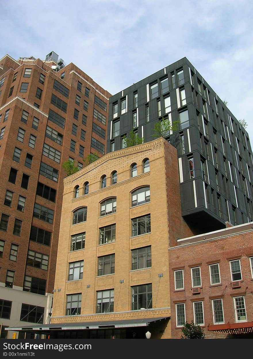 Modern building extension built onto an older brick building.  New York City. Modern building extension built onto an older brick building.  New York City.