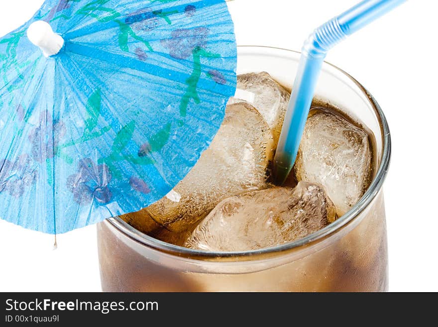 Cold fizzy cola with ice in a glass. Close up.