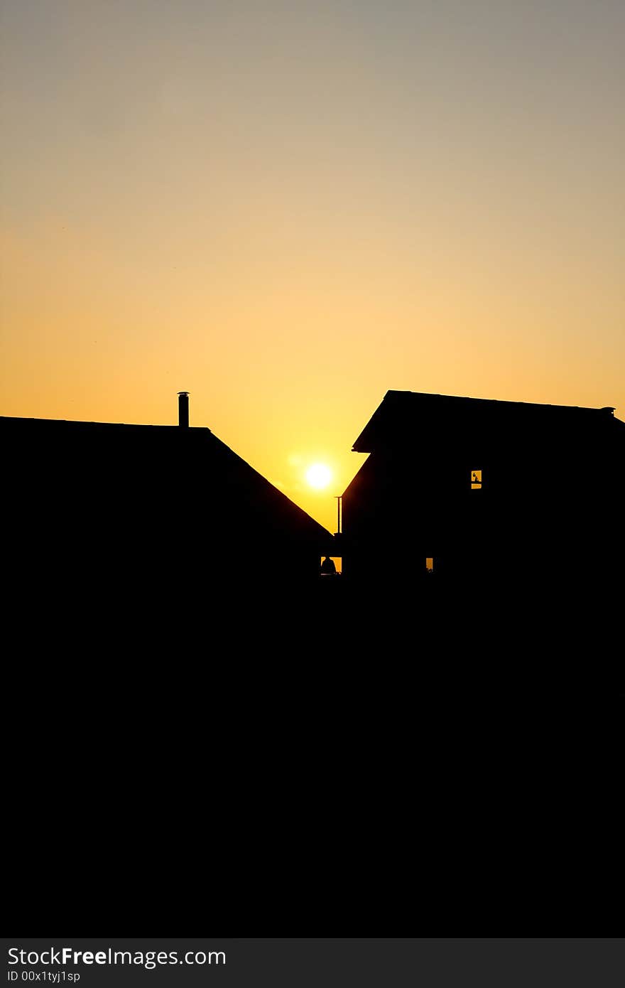 Sunset silhouette of house