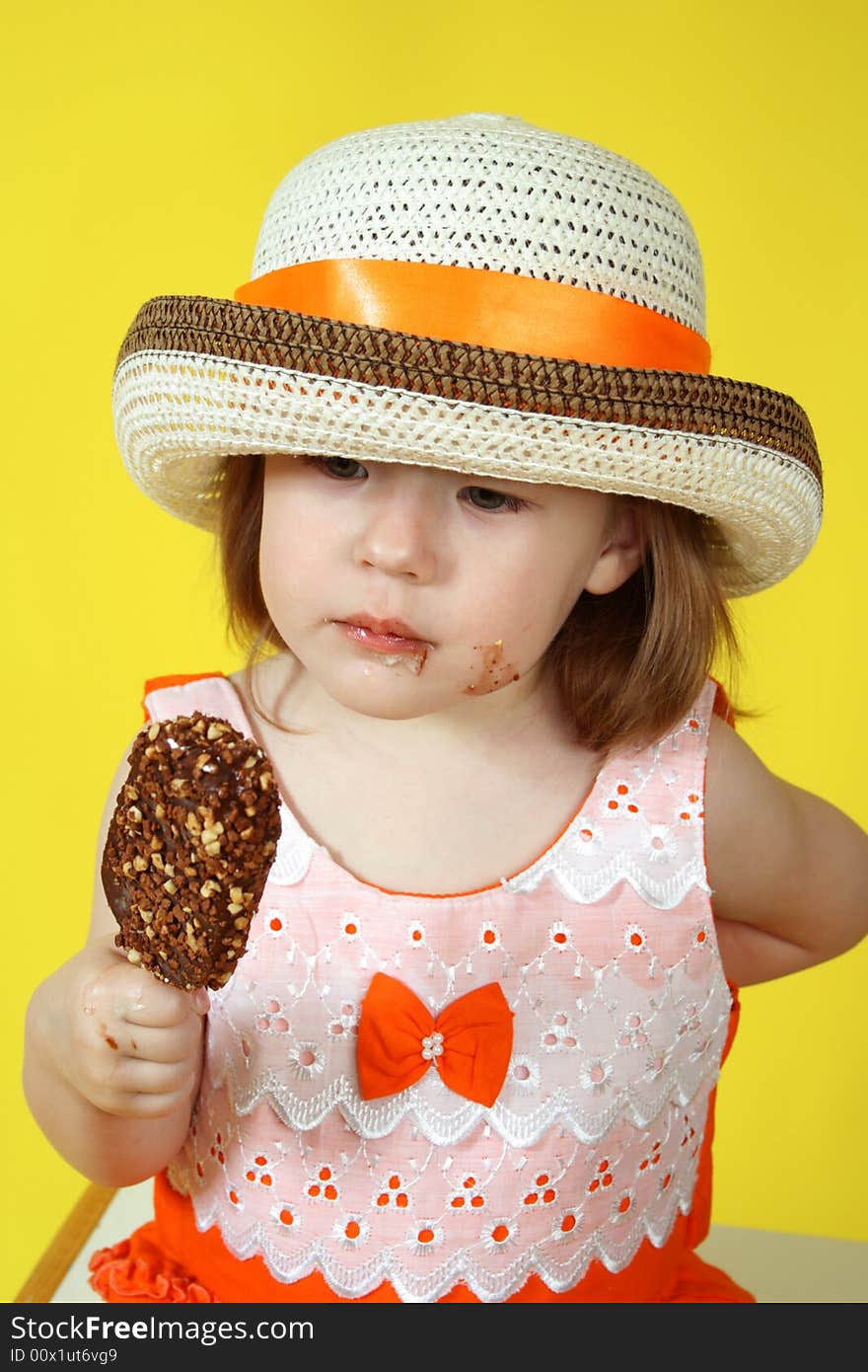Small girl is eating chocolate ice-cream with nuts. Small girl is eating chocolate ice-cream with nuts