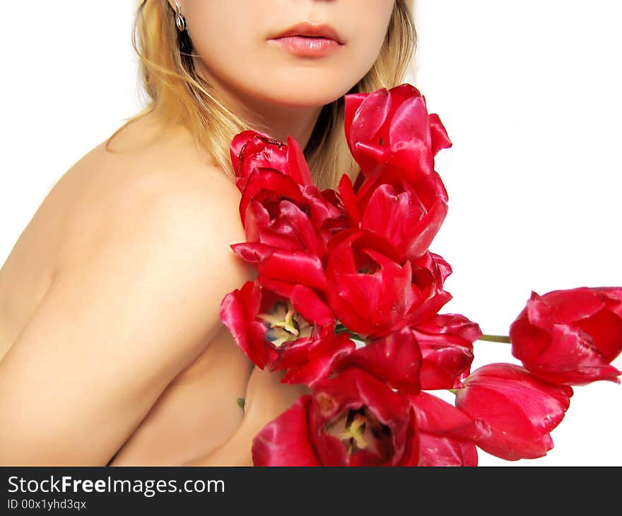 Sensual part of woman's body holding tulips on white