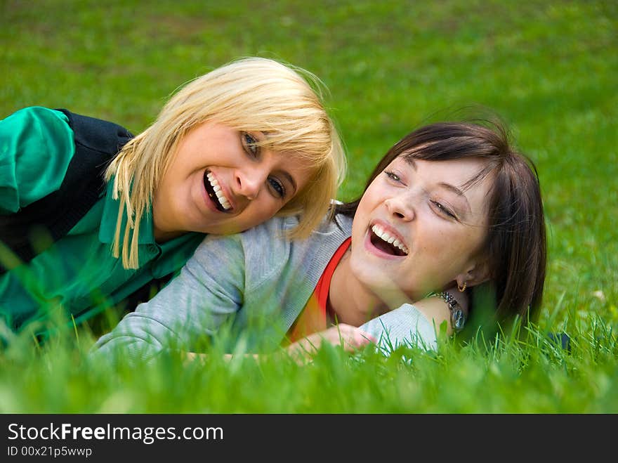 Laughing Happy blonde and brunette playing on the nature. Laughing Happy blonde and brunette playing on the nature