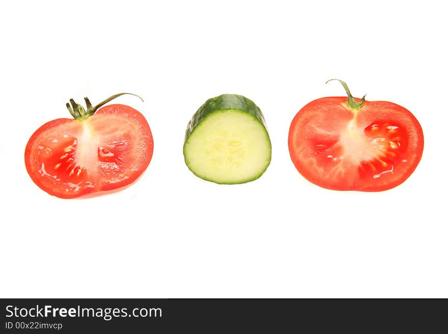 Cut tomatoes and cucumber isolated on a white background. Cut tomatoes and cucumber isolated on a white background