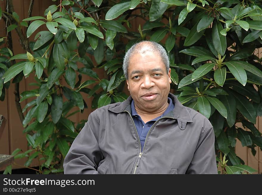 Portrait of a african american male relaxing on his patio outdoors.