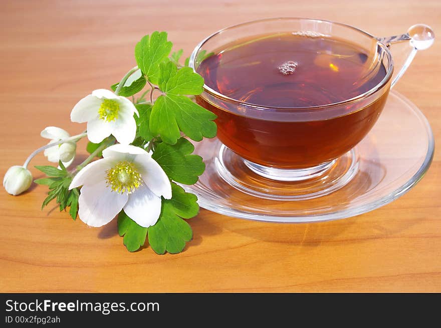 Bouquet of spring flowers and cup of tea