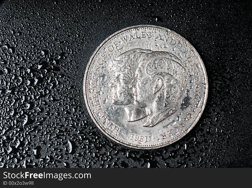 A view with a coins on a wet black background