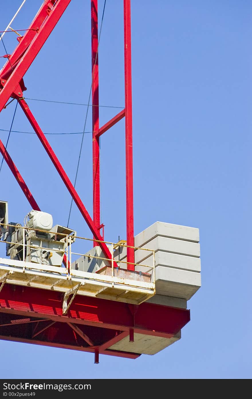 Construction crane busy at work on a sunny day with blue sky