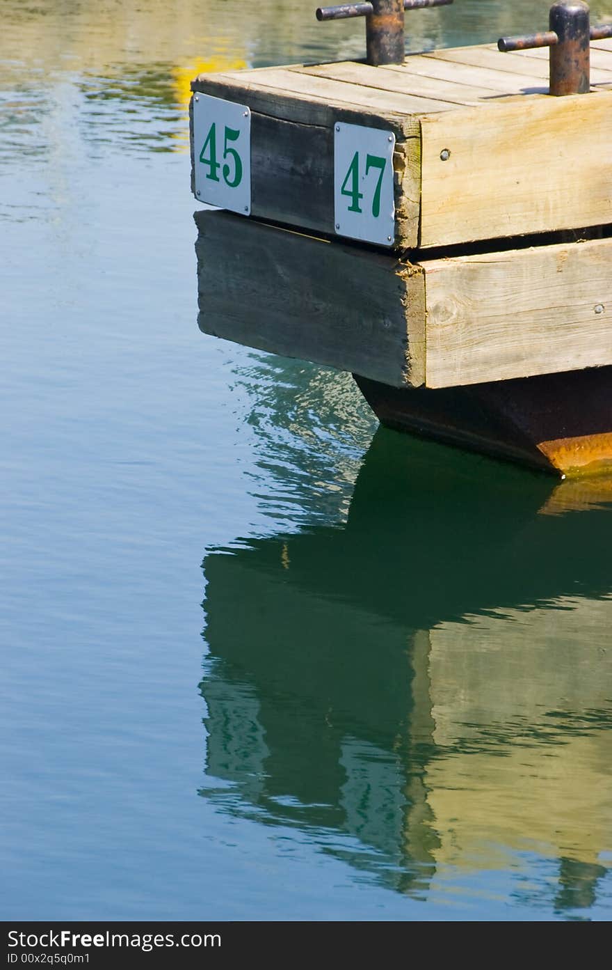 A reflection of a dock in the water at a marina. A reflection of a dock in the water at a marina