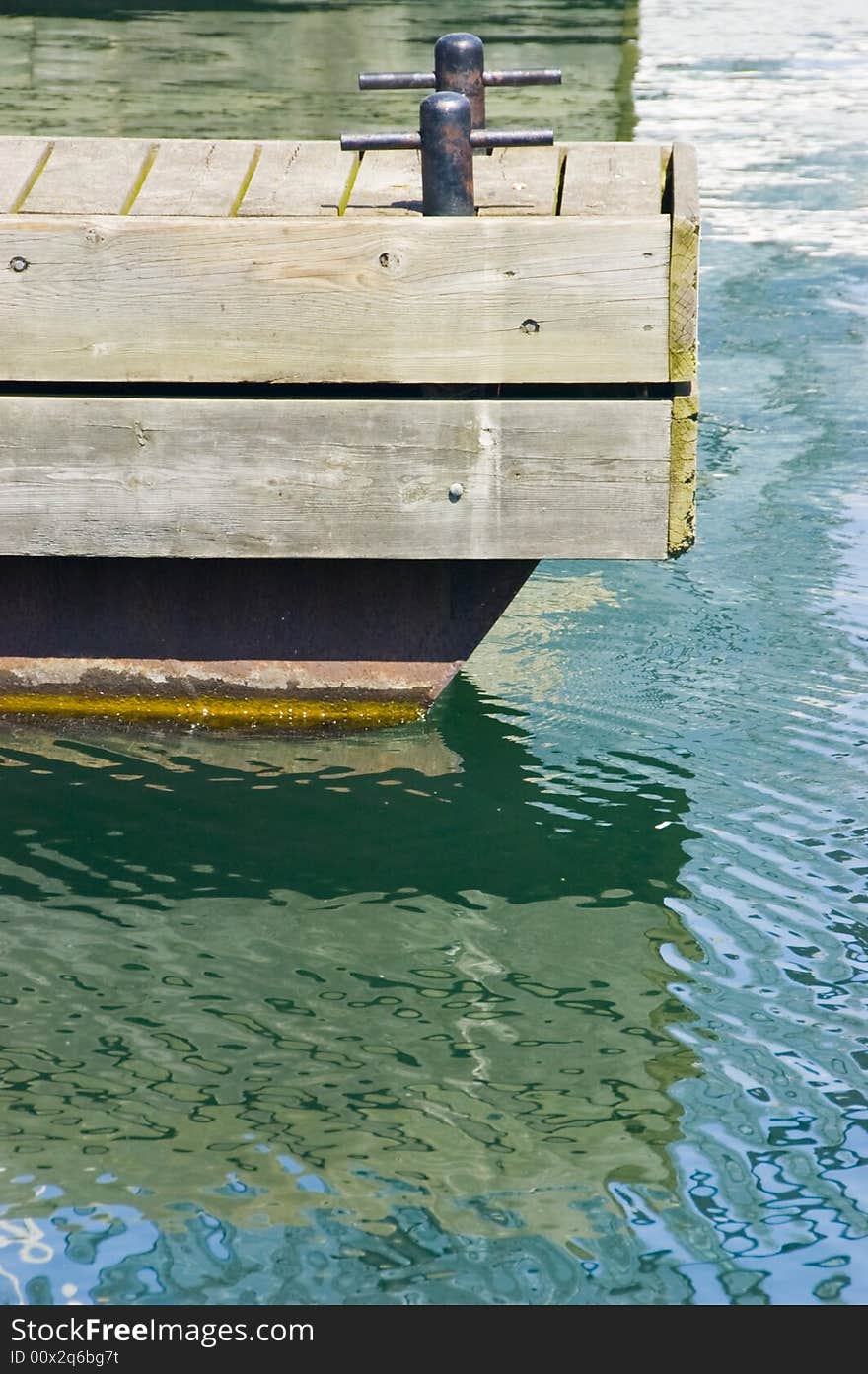 A reflection of a dock in the water at a marina. A reflection of a dock in the water at a marina