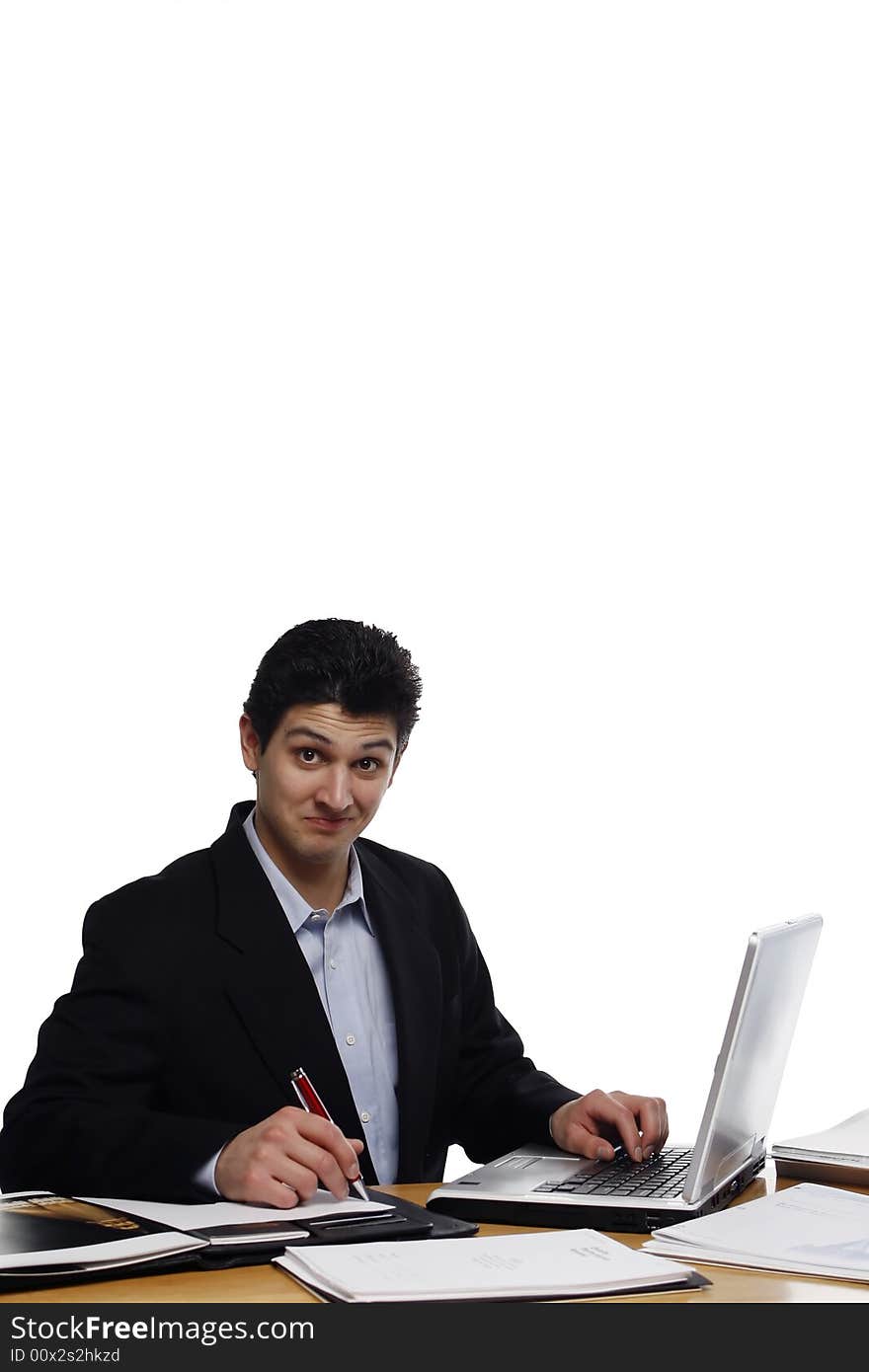 Businessman sitting at a desk with smug look on his face looking at the camera. Vertical isolated on white. Businessman sitting at a desk with smug look on his face looking at the camera. Vertical isolated on white.