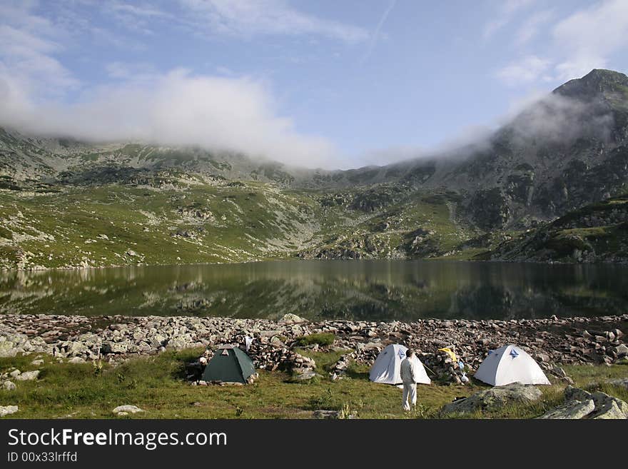 Mountain landscape with tent camp on the morning time