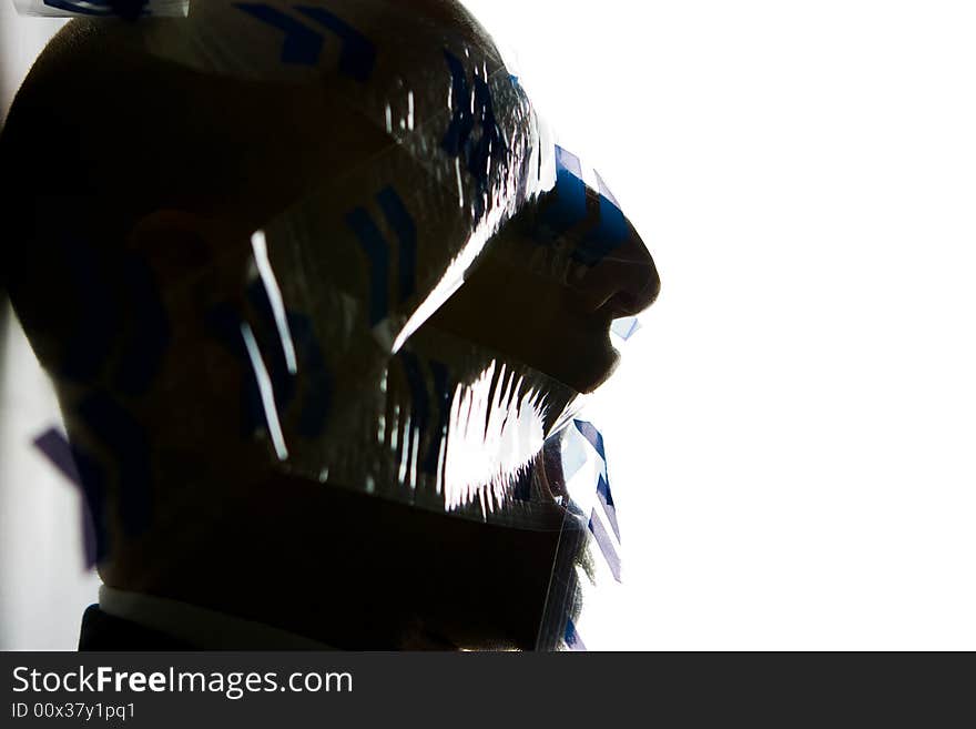 An abstract silhouetted profile of a man under extreme stress. An abstract silhouetted profile of a man under extreme stress.