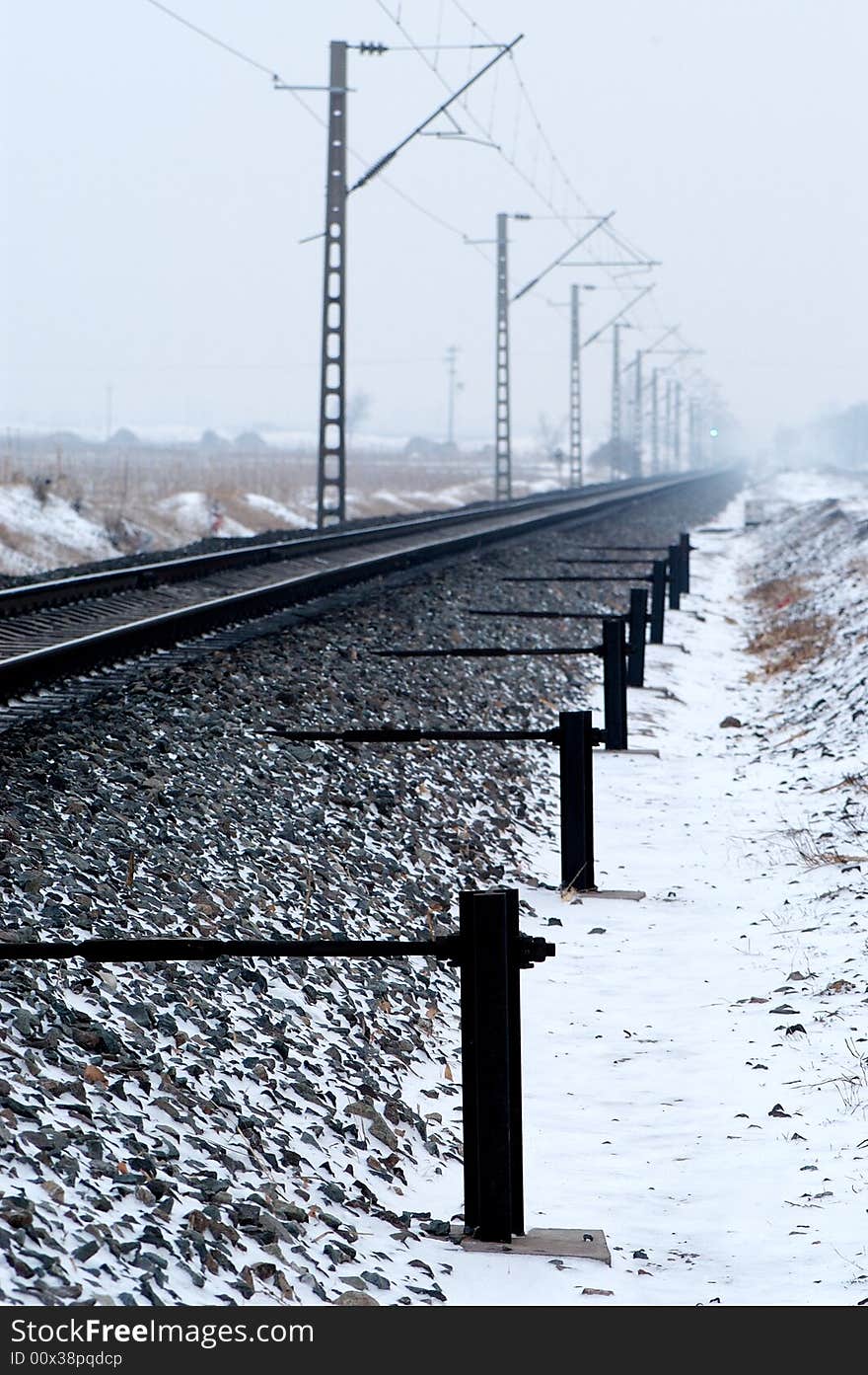 Railway spread out far beyond the horizon on the snow covered land. Railway spread out far beyond the horizon on the snow covered land.