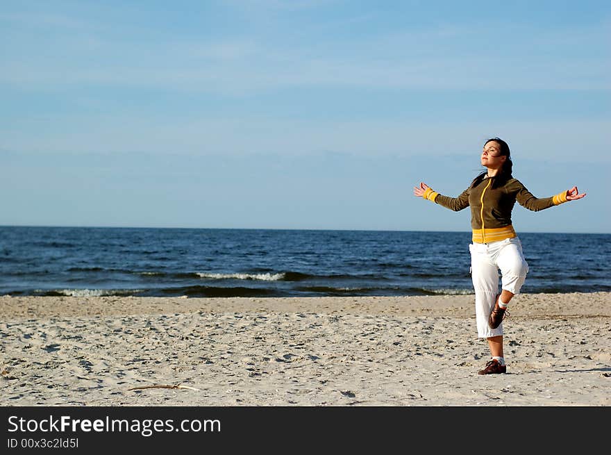 Attractive woman doing exercise on the beach. Attractive woman doing exercise on the beach