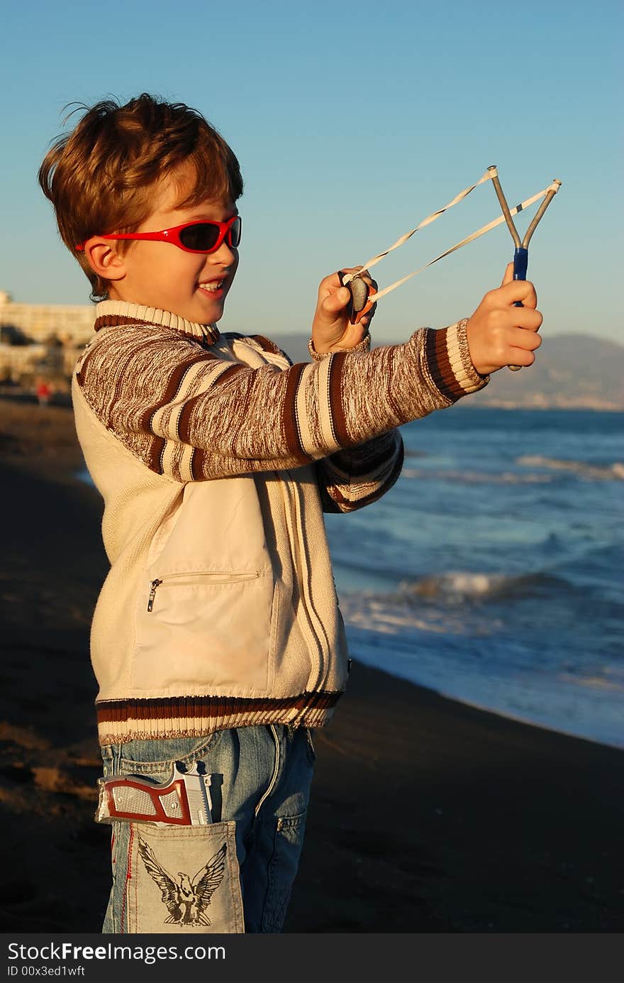 The boy plays on a beach