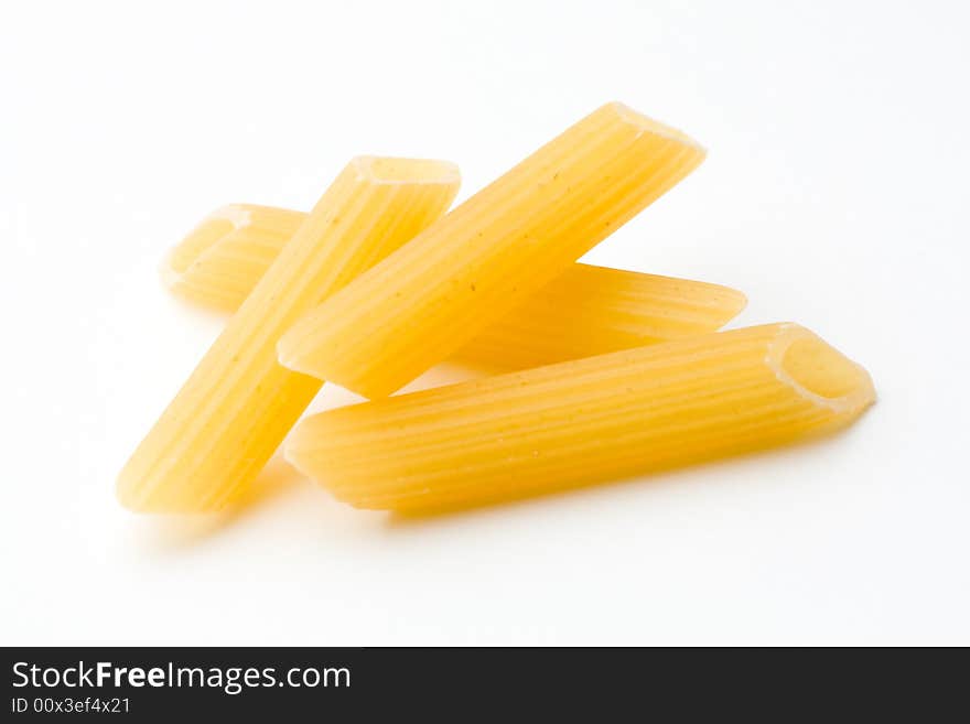 Yellow penne on white background