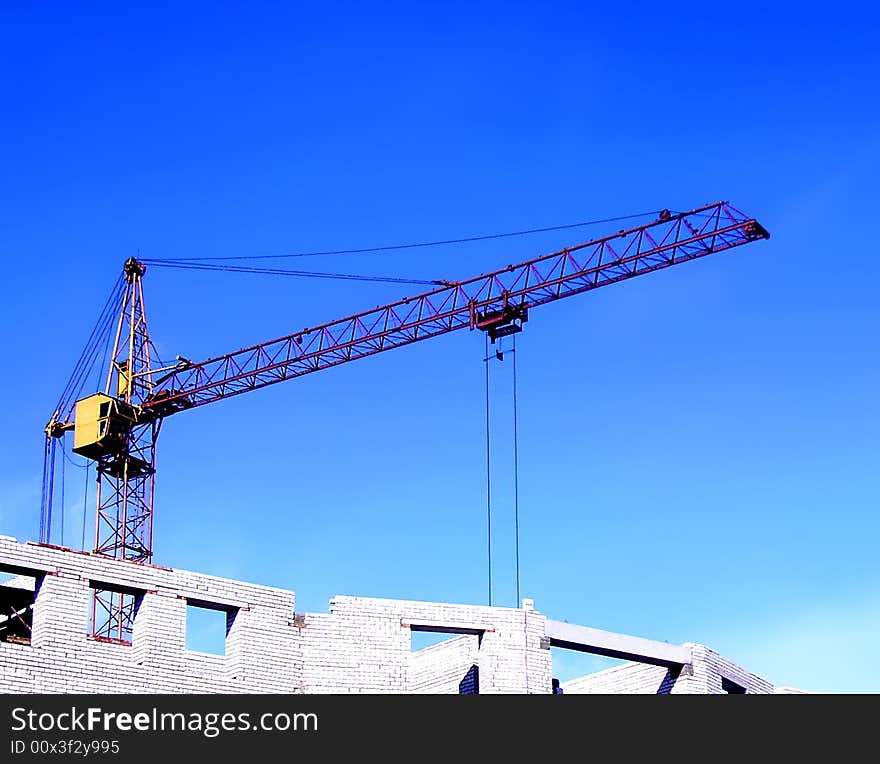 Construction of a new building by the hoisting crane. Construction of a new building by the hoisting crane.