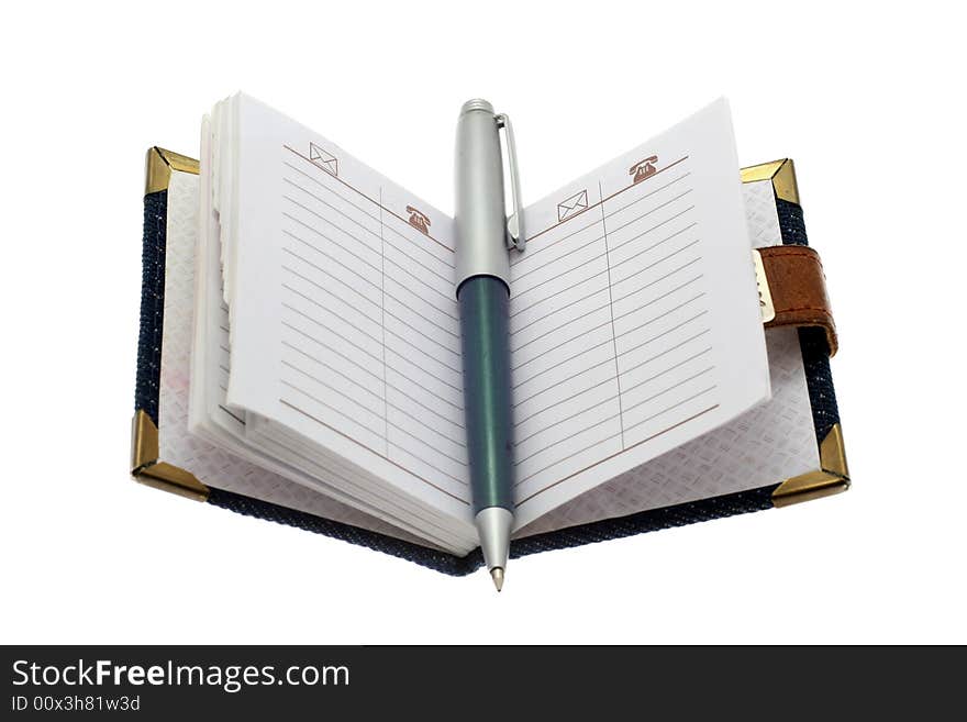 The opened notebook and ball pen on a white background