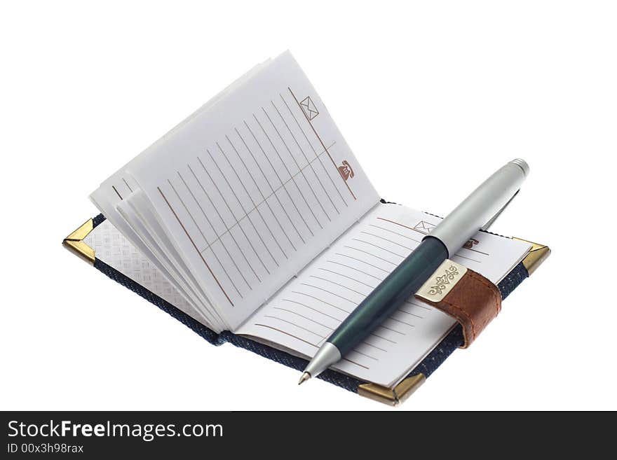 The opened notebook and ball pen on a white background